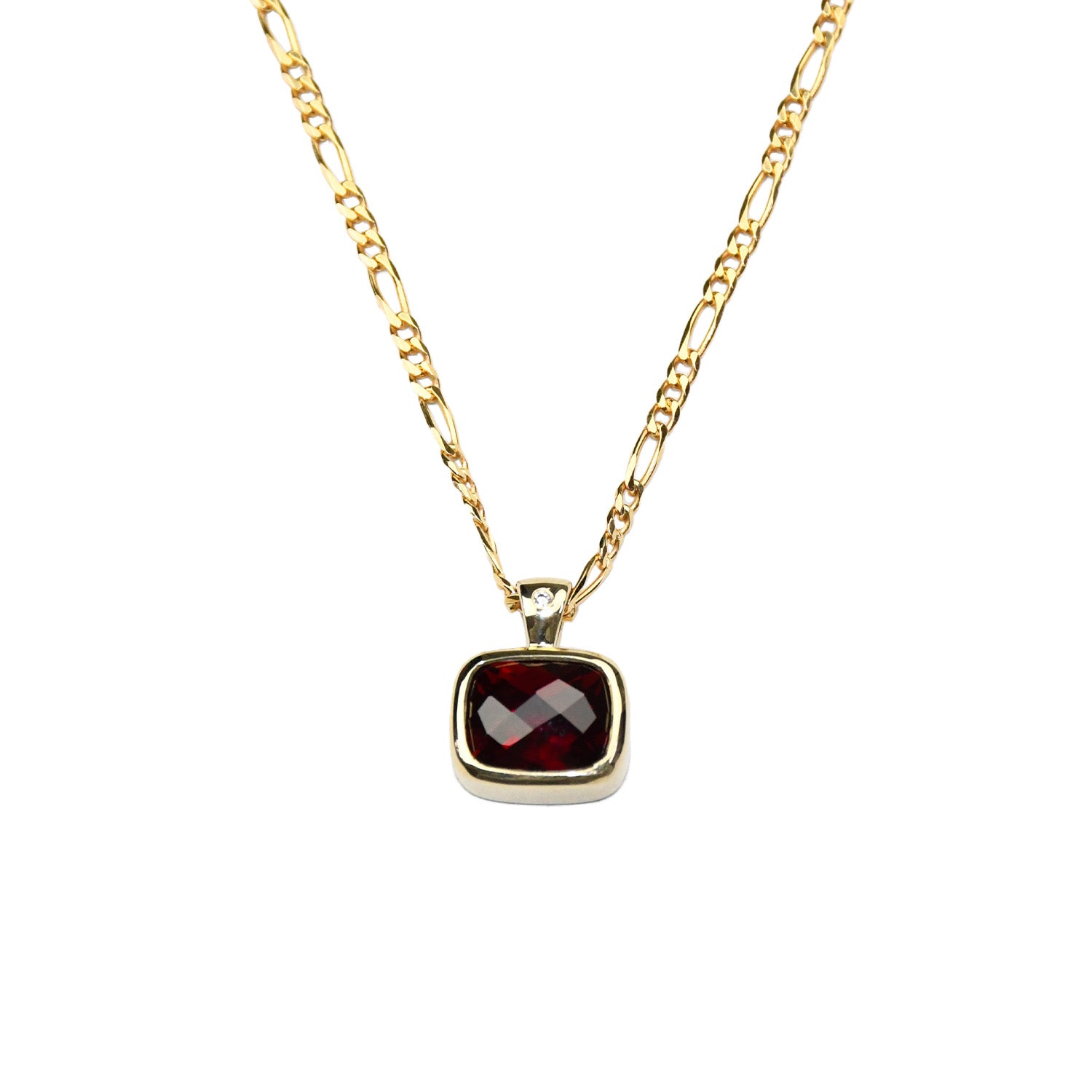 close up of pendant: laura miers 9ct yellow gold necklace with bezel encased, emerald cut  hyrdothermal ruby pendant