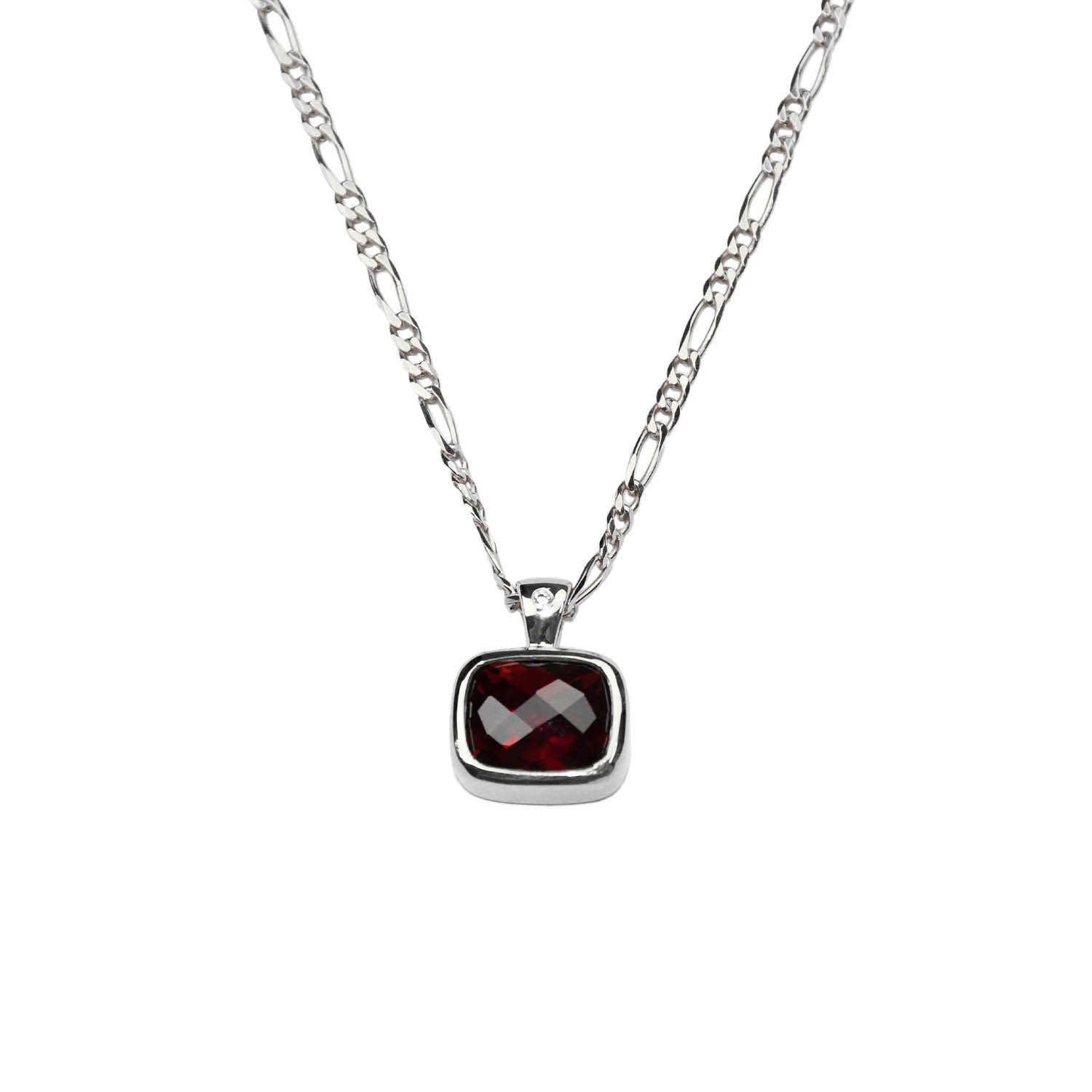 close up of pendant: laura miers silver necklace with bezel encased, emerald cut hyrdothermal ruby pendant