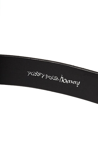 inside of black leather belt with engraving that reads 'pussy pour homme'